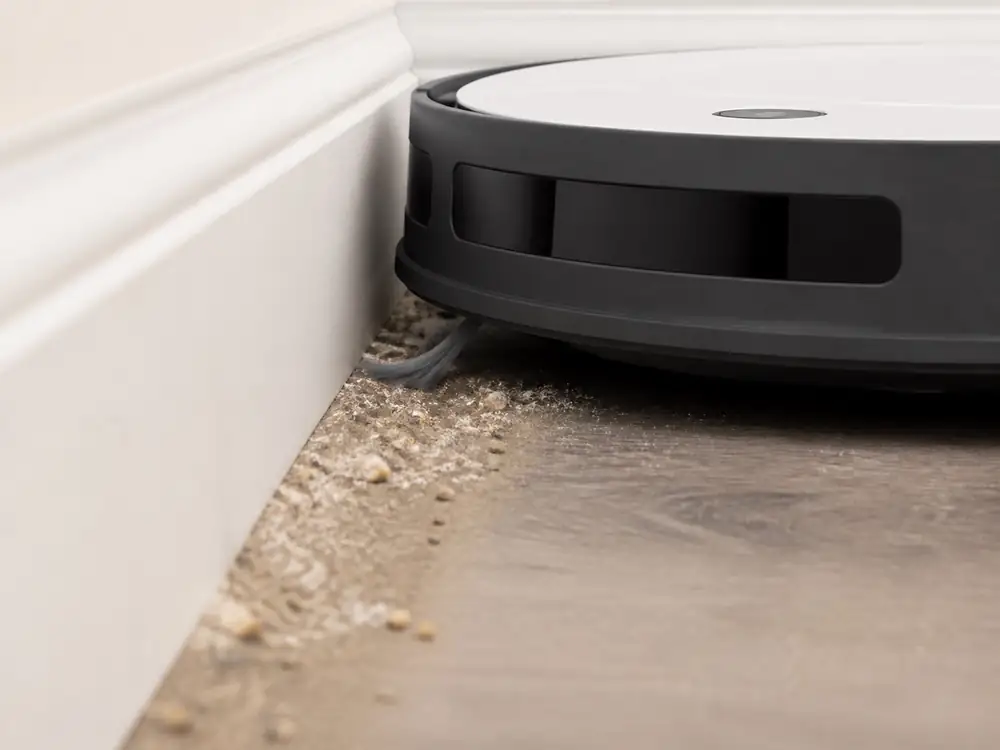 AI-generated close-up: Robot vacuum cleaner removes dust on the edge